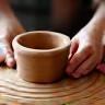 Artisan shaping clay on a potter's wheel