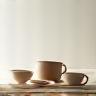 Collection of modern tableware designs on a minimalist shelf